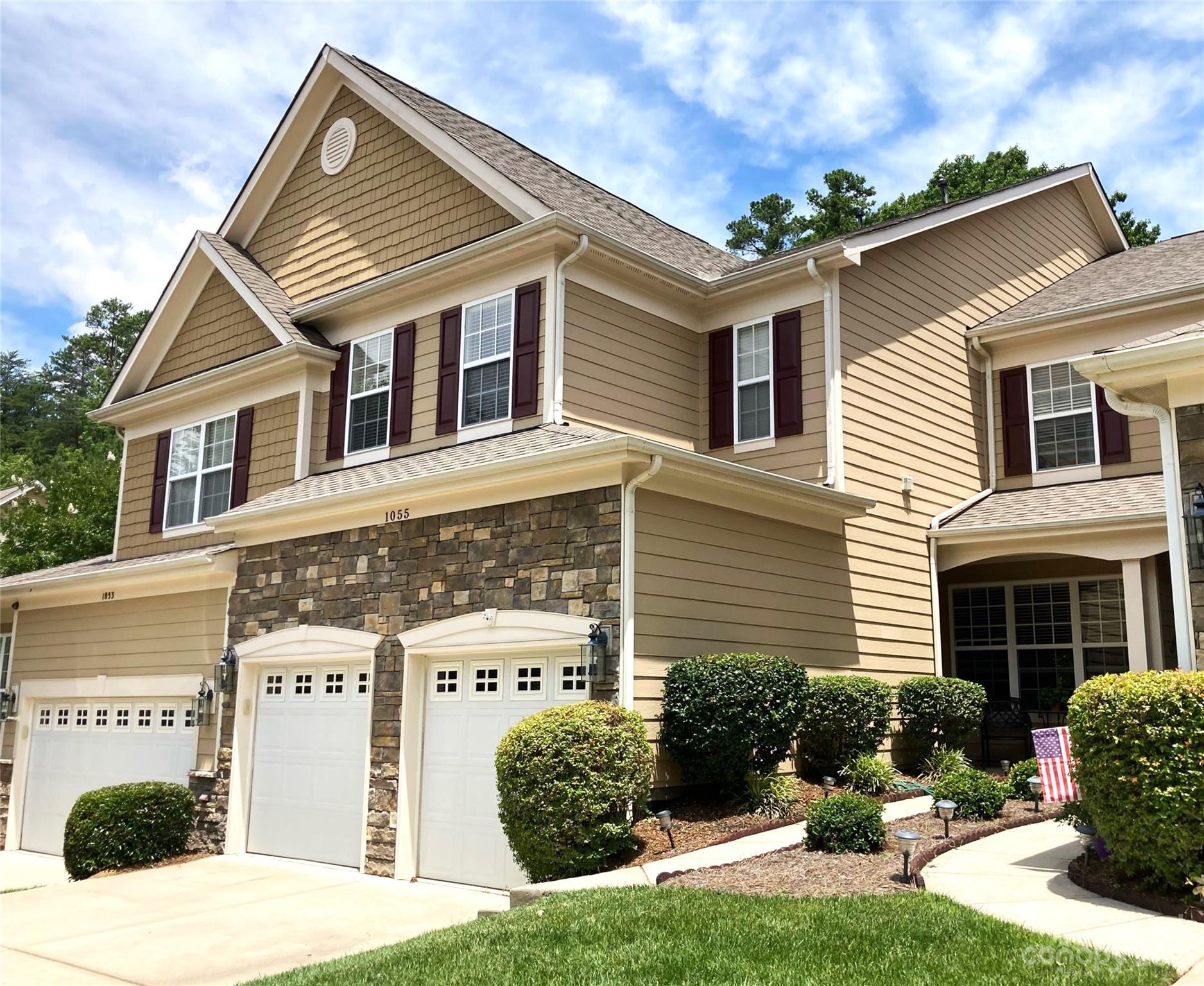 1055 Silver Gull Drive Tega Cay, SC 29708 - Photo 1 of 35 a front view of a house with a yard and potted plants
