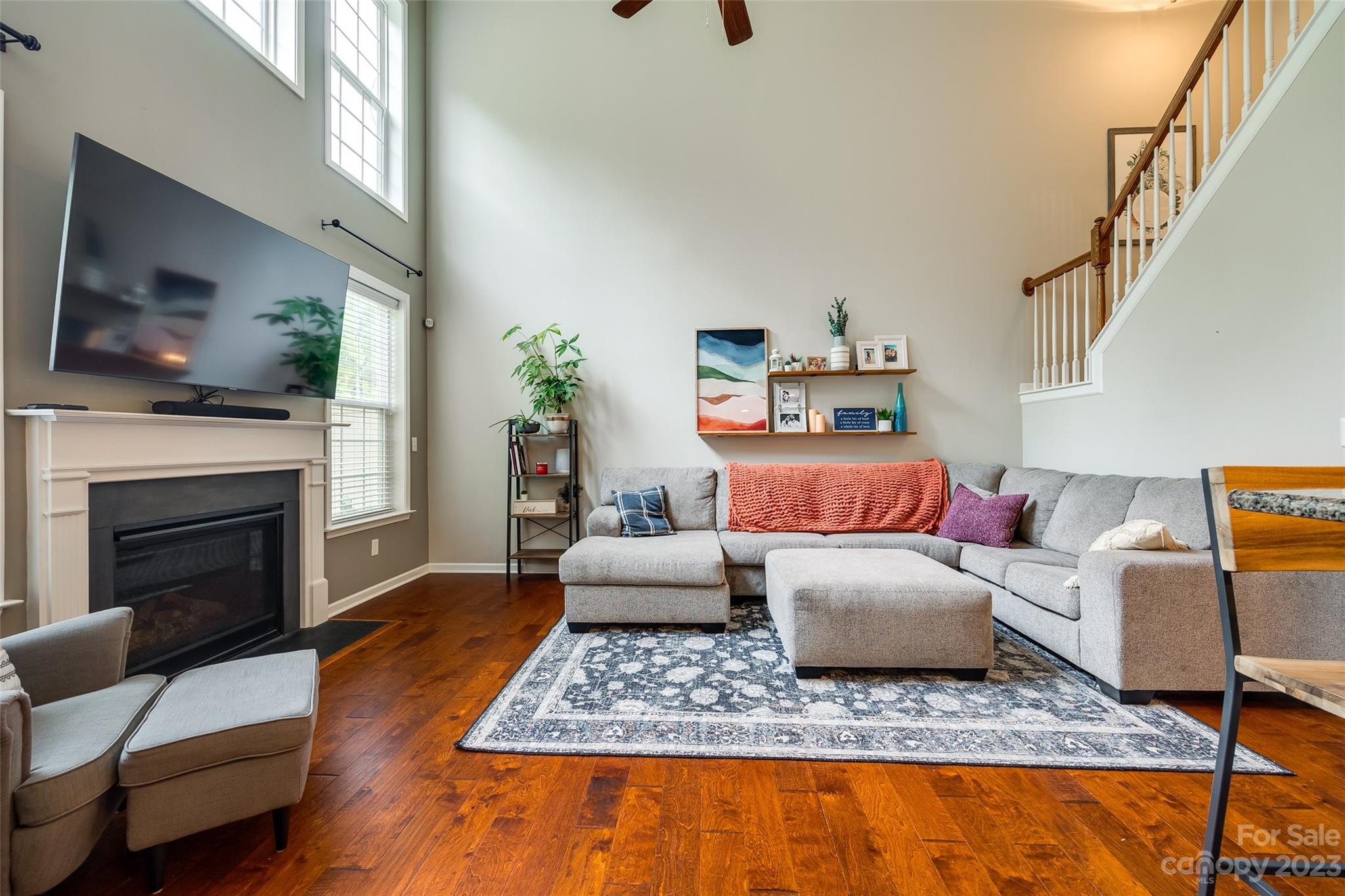 1055 Silver Gull Drive Tega Cay, SC 29708 - Photo 12 of 35 a living room with furniture a flat screen tv and a fireplace