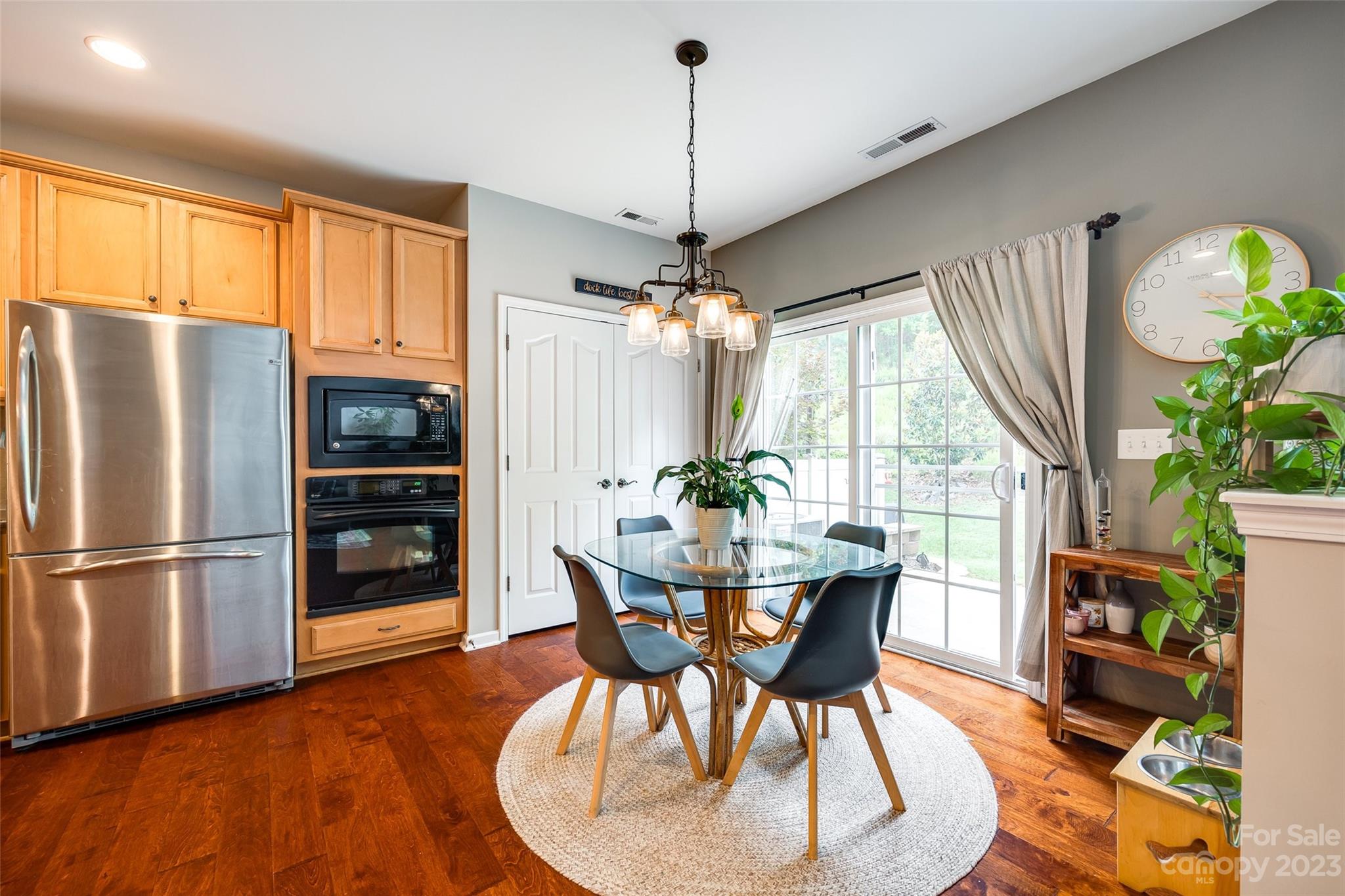 1055 Silver Gull Drive Tega Cay, SC 29708 - Photo 14 of 35 a dining room with furniture a chandelier and wooden floor