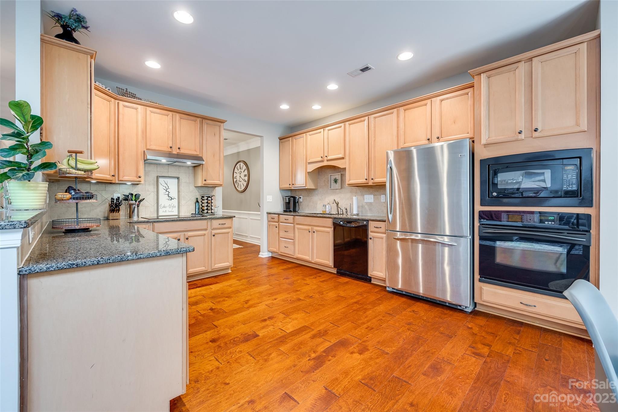 1055 Silver Gull Drive Tega Cay, SC 29708 - Photo 16 of 35 a kitchen with stainless steel appliances granite countertop a refrigerator sink and cabinets