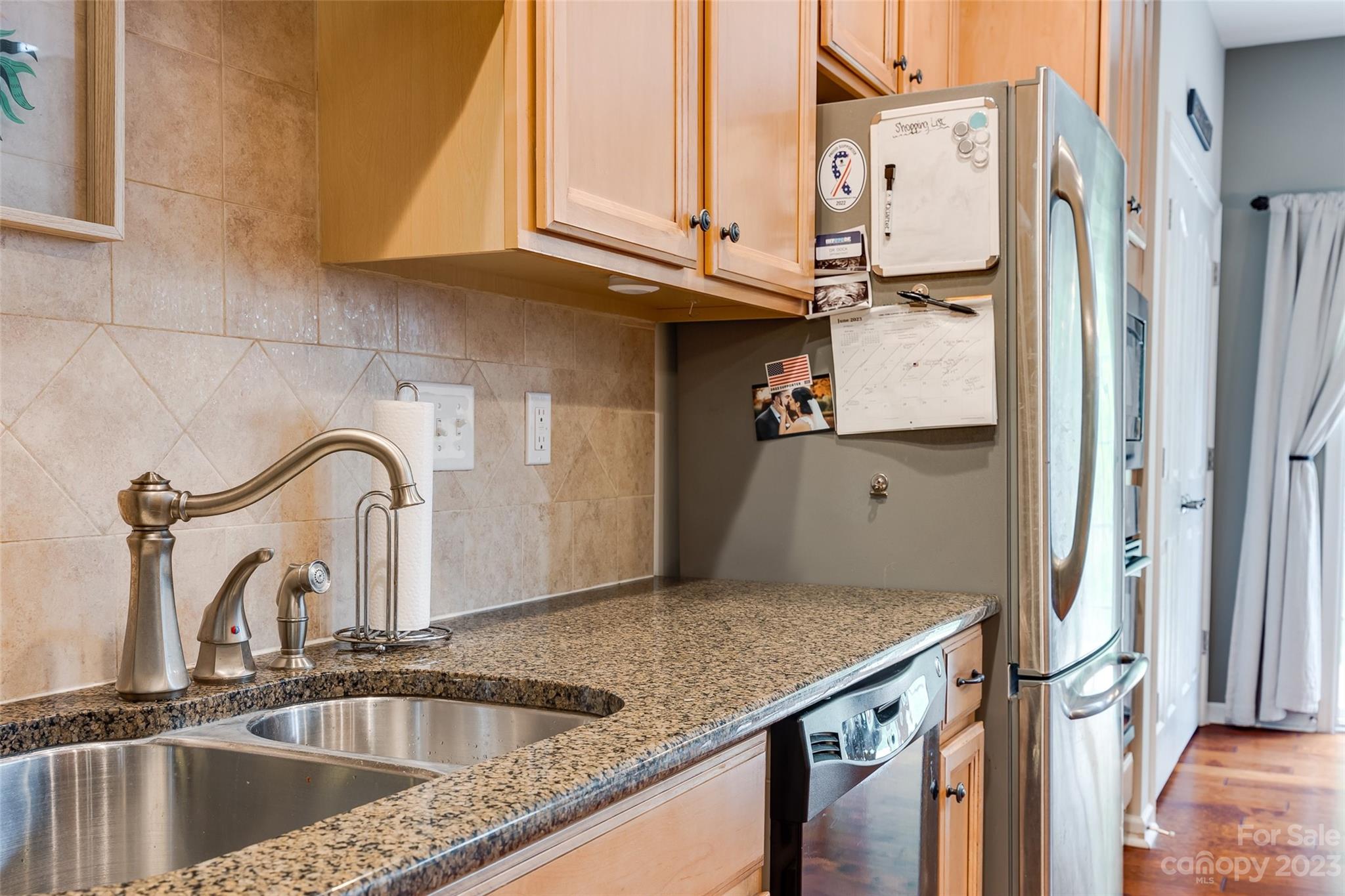 1055 Silver Gull Drive Tega Cay, SC 29708 - Photo 18 of 35 a kitchen with stainless steel appliances granite countertop a sink and a counter top space