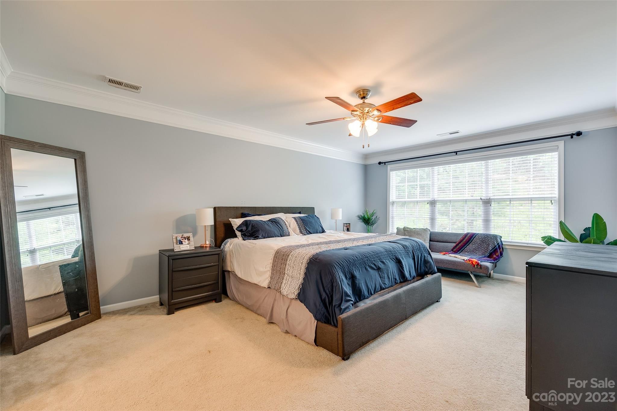 1055 Silver Gull Drive Tega Cay, SC 29708 - Photo 21 of 35 a spacious bedroom with a bed and a large window