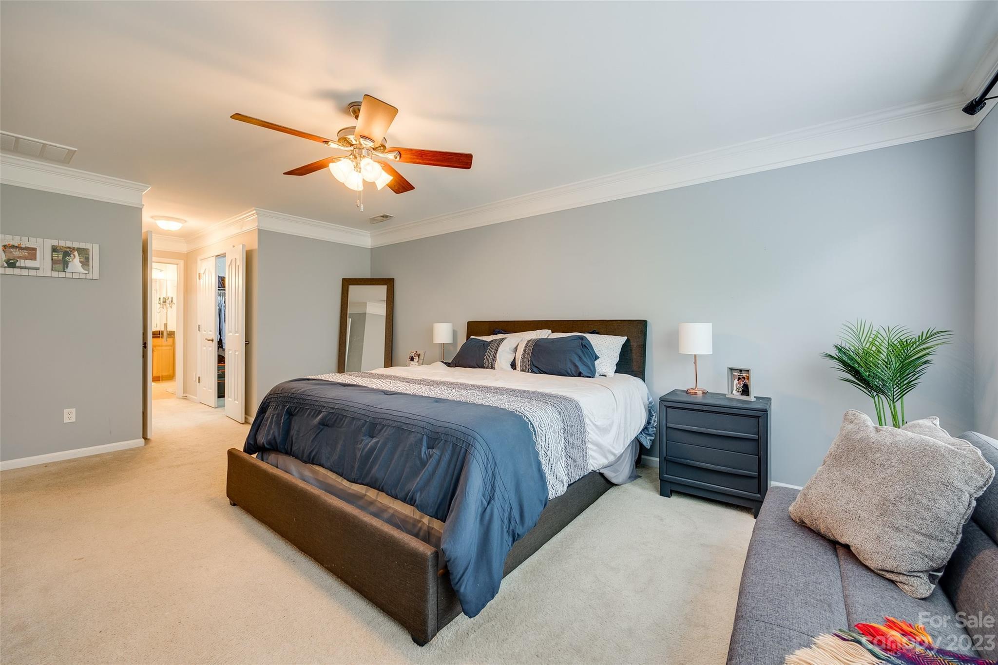 1055 Silver Gull Drive Tega Cay, SC 29708 - Photo 22 of 35 a spacious bedroom with a bed and a chandelier