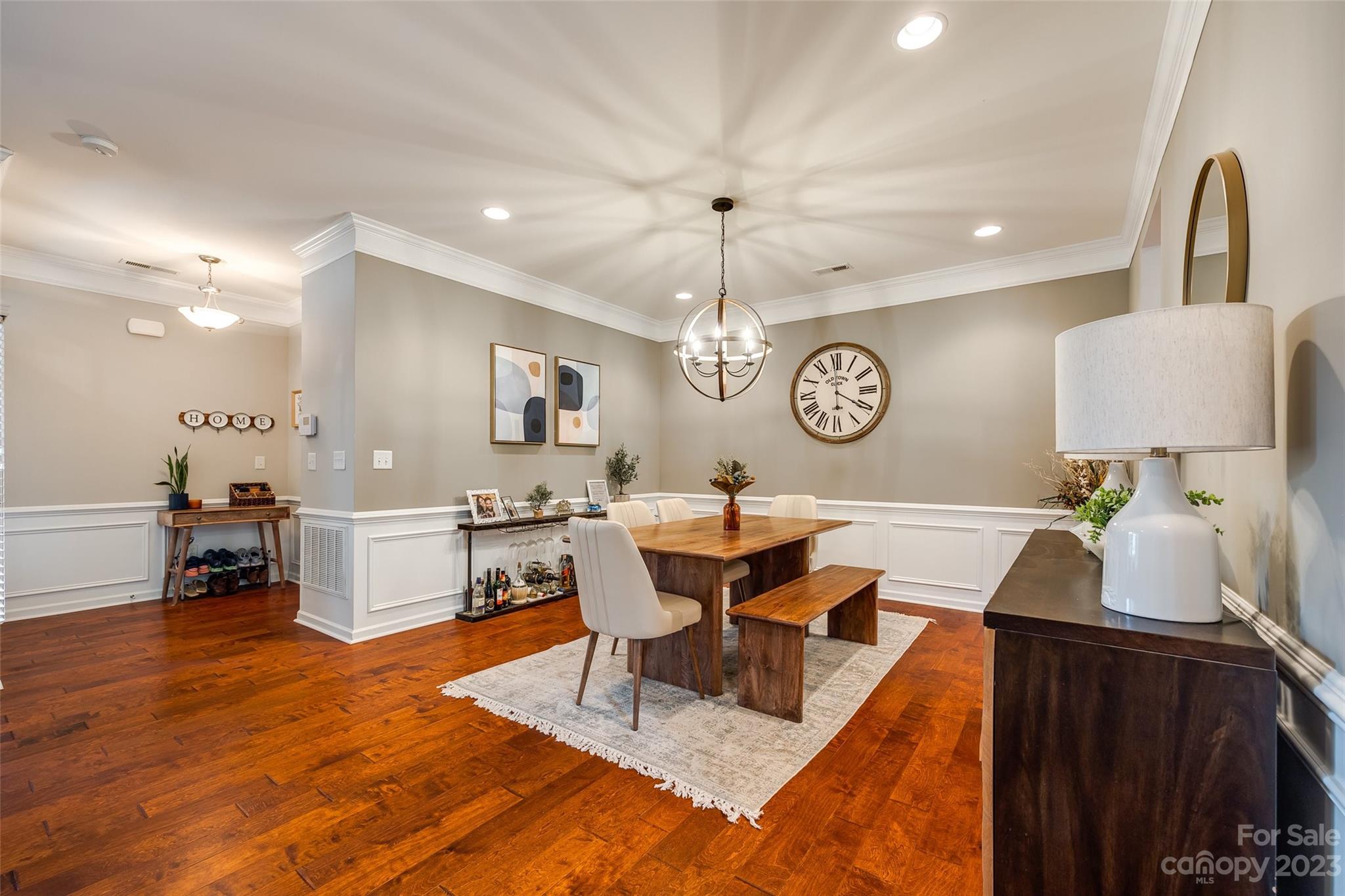1055 Silver Gull Drive Tega Cay, SC 29708 - Photo 8 of 35 a living room with couches a dining table with kitchen view with wooden floor