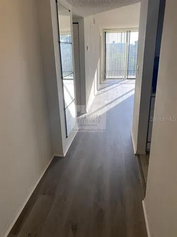a white refrigerator freezer and a stove sitting inside of a kitchen