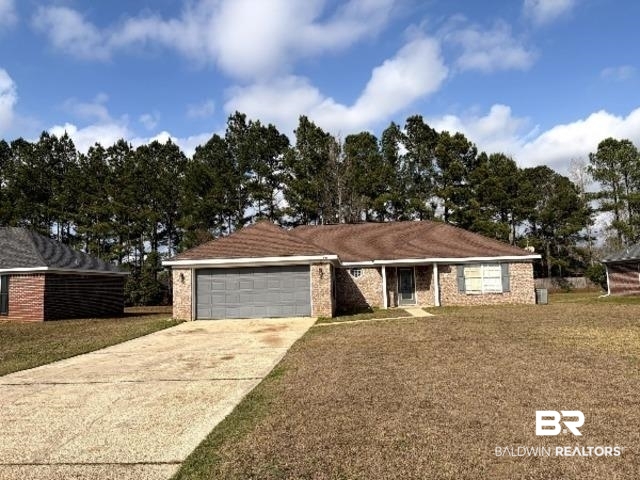 521 Hamilton Boulevard Foley, AL 36535 - Photo 2 of 6 Single story home featuring driveway, a garage, brick siding, and a front yard