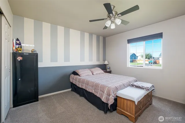 a view of a house with backyard and wooden fence