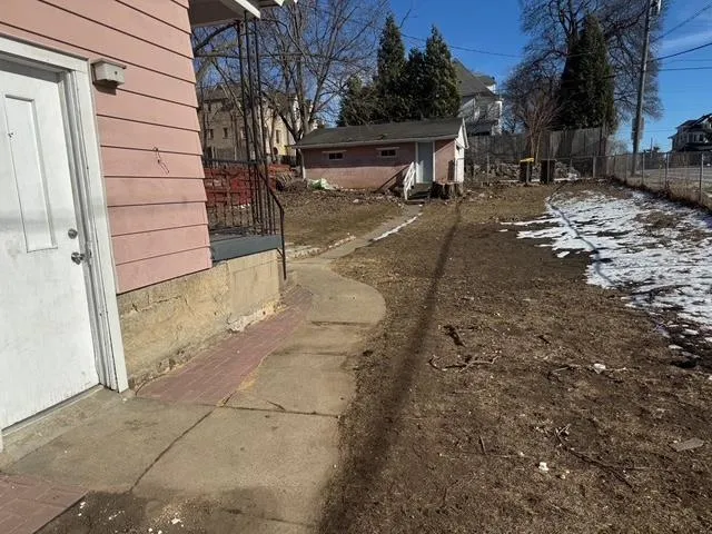 a view of a yard with a tree