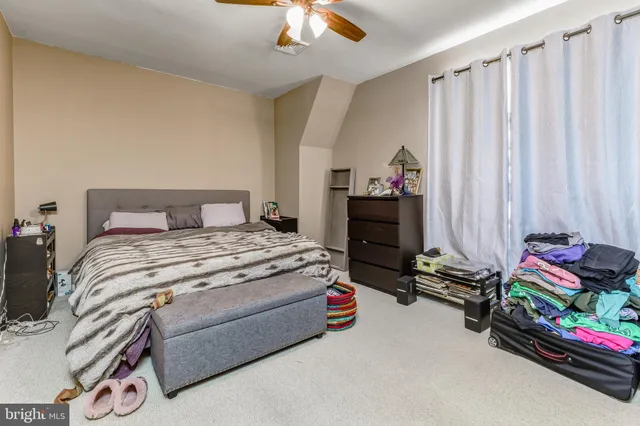 a bedroom with bed and a chandelier