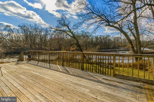 a view of balcony with wooden floor and fence