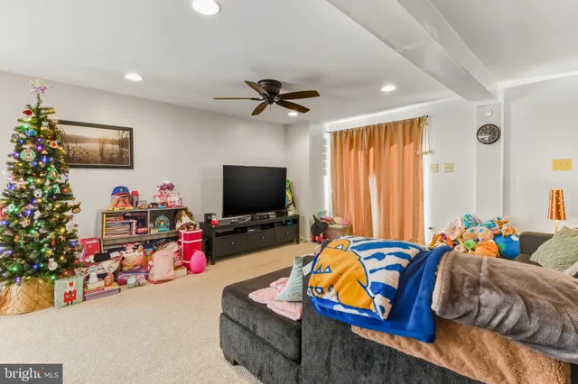 a bedroom with furniture and a flat screen tv