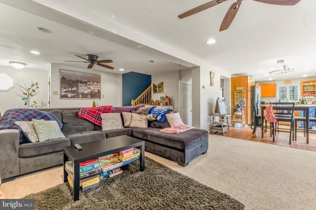 a living room with furniture a rug and a chandelier