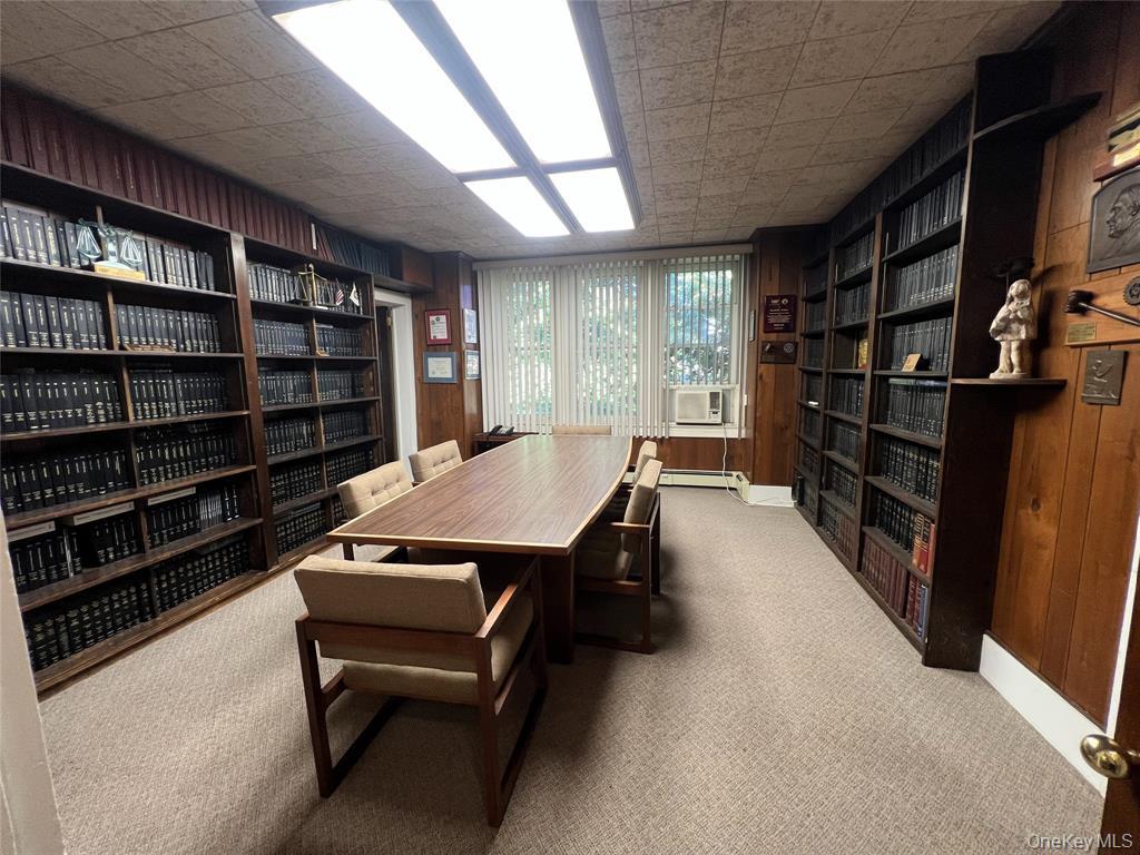 2566 Middle Country Road Centereach, NY 11720 - Photo 11 of 31 a room with furniture and a book shelf