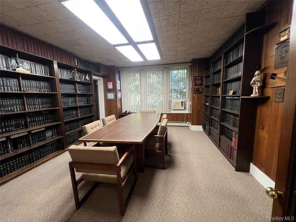 2566 Middle Country Road Centereach, NY 11720 - Photo 13 of 31 a room with furniture a rug and a book shelf