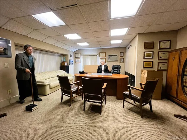 a living room with furniture and a work place area