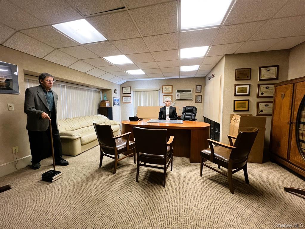 2566 Middle Country Road Centereach, NY 11720 - Photo 10 of 31 a living room with furniture and a work place area