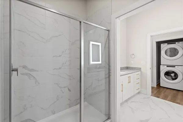 a bathroom with a bathtub and a washing machine