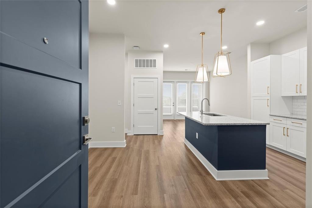 2648 Sandy Plains Road, Unit 424 Marietta, GA 30062 - Photo 22 of 33 a large kitchen with a lot of counter space and wooden floor