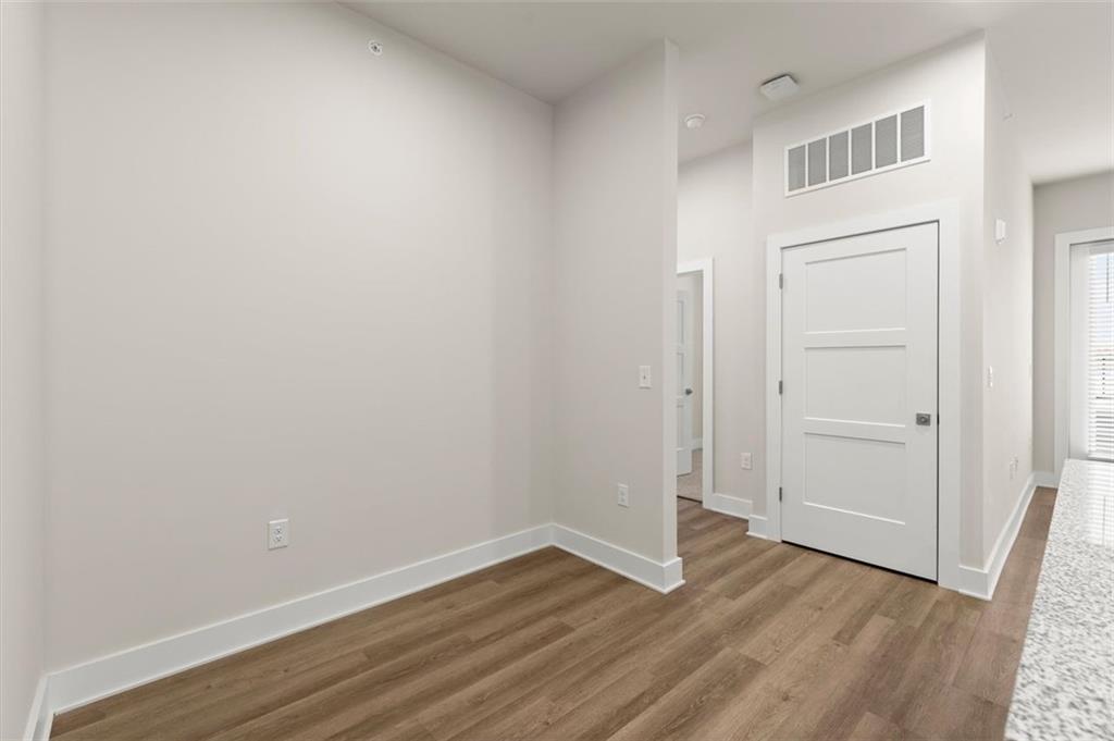 2648 Sandy Plains Road, Unit 424 Marietta, GA 30062 - Photo 8 of 33 a view of an empty room with wooden floor