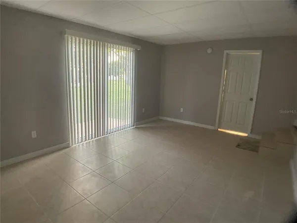 an empty room with wooden floor and entrance