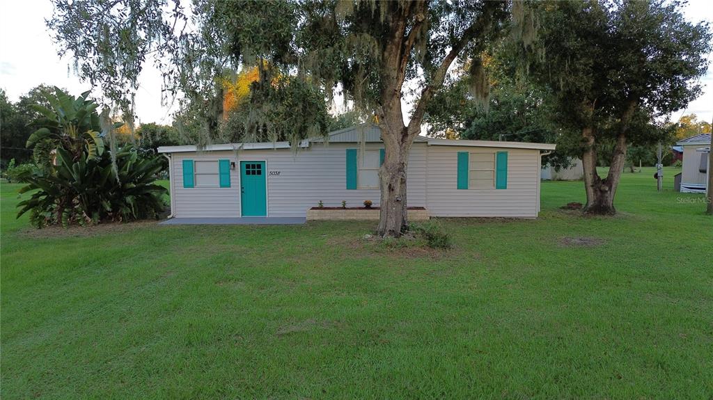 5038 Northeast Sandy Road Arcadia, FL 34266 - Photo 2 of 48 front view of house with a yard and potted plants