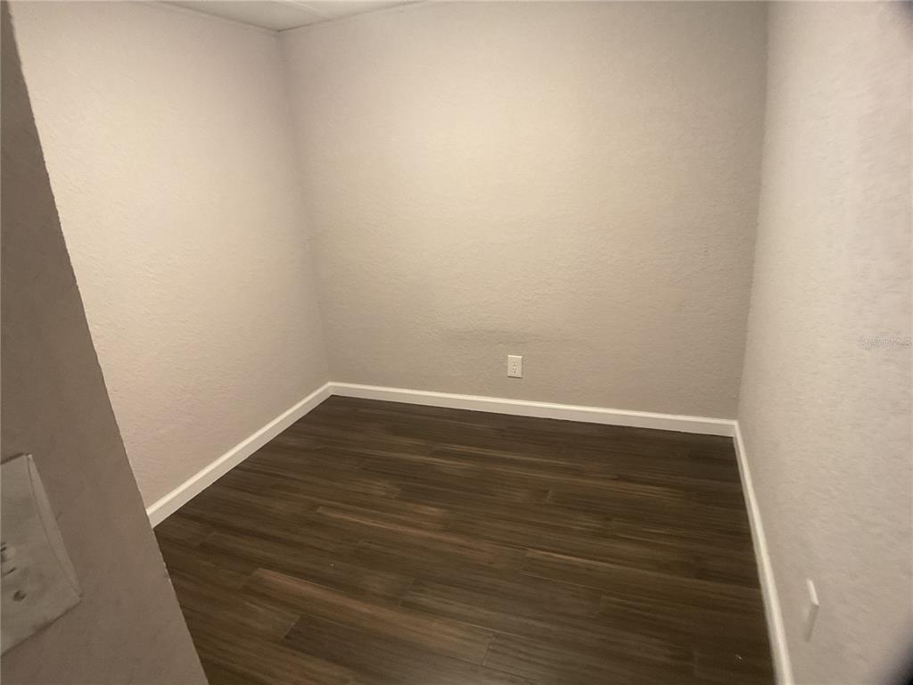 5038 Northeast Sandy Road Arcadia, FL 34266 - Photo 21 of 48 a view of an empty room with wooden floor