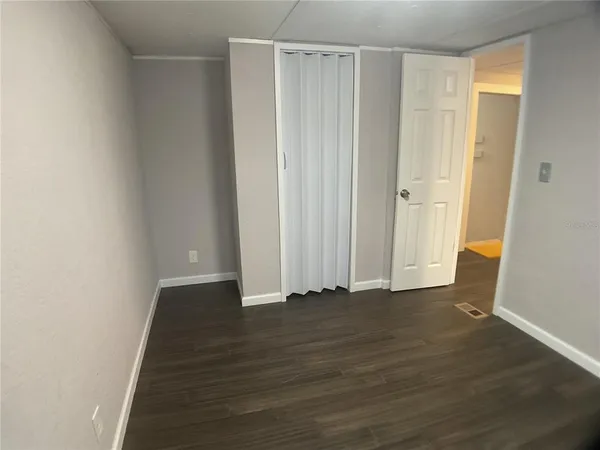 a bathroom with a granite countertop sink a toilet mirror and vanity