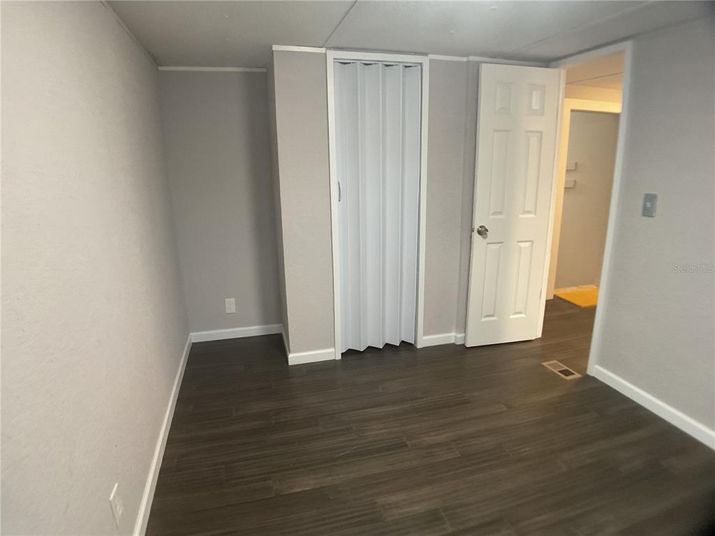 5038 Northeast Sandy Road Arcadia, FL 34266 - Photo 25 of 48 a view of an empty room with wooden floor