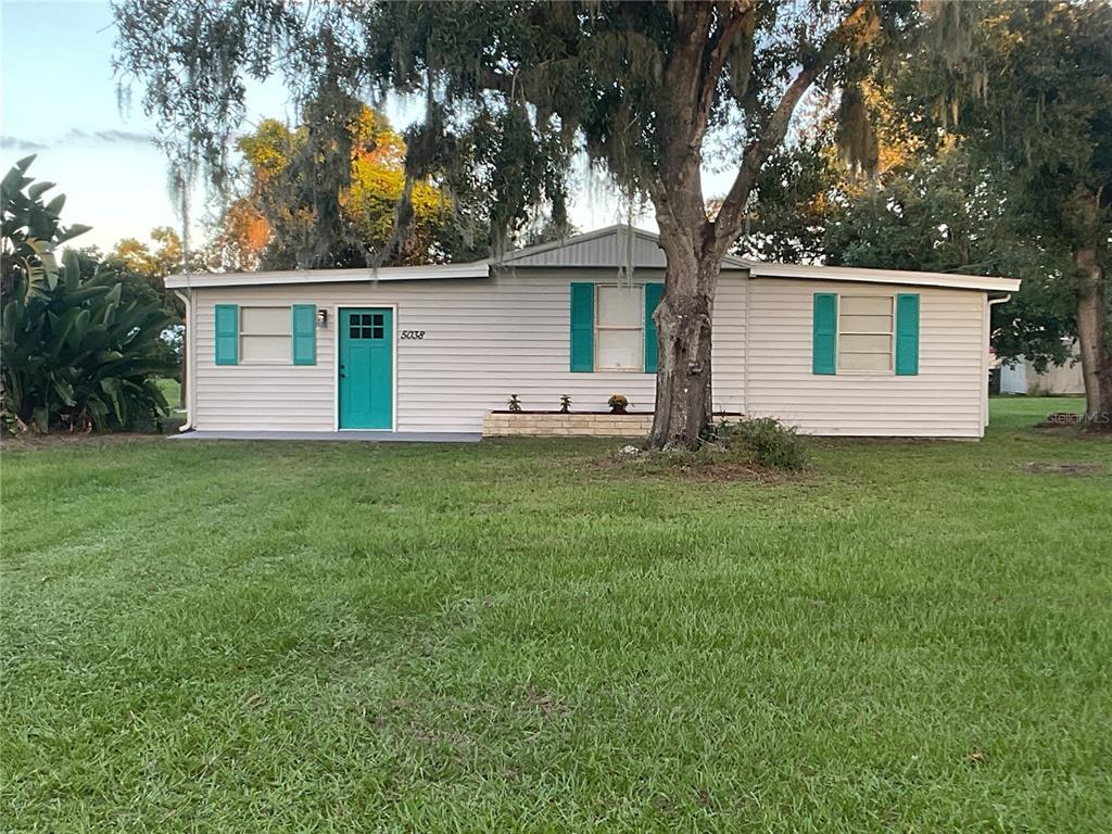5038 Northeast Sandy Road Arcadia, FL 34266 - Photo 45 of 48 a front view of house with yard and trees
