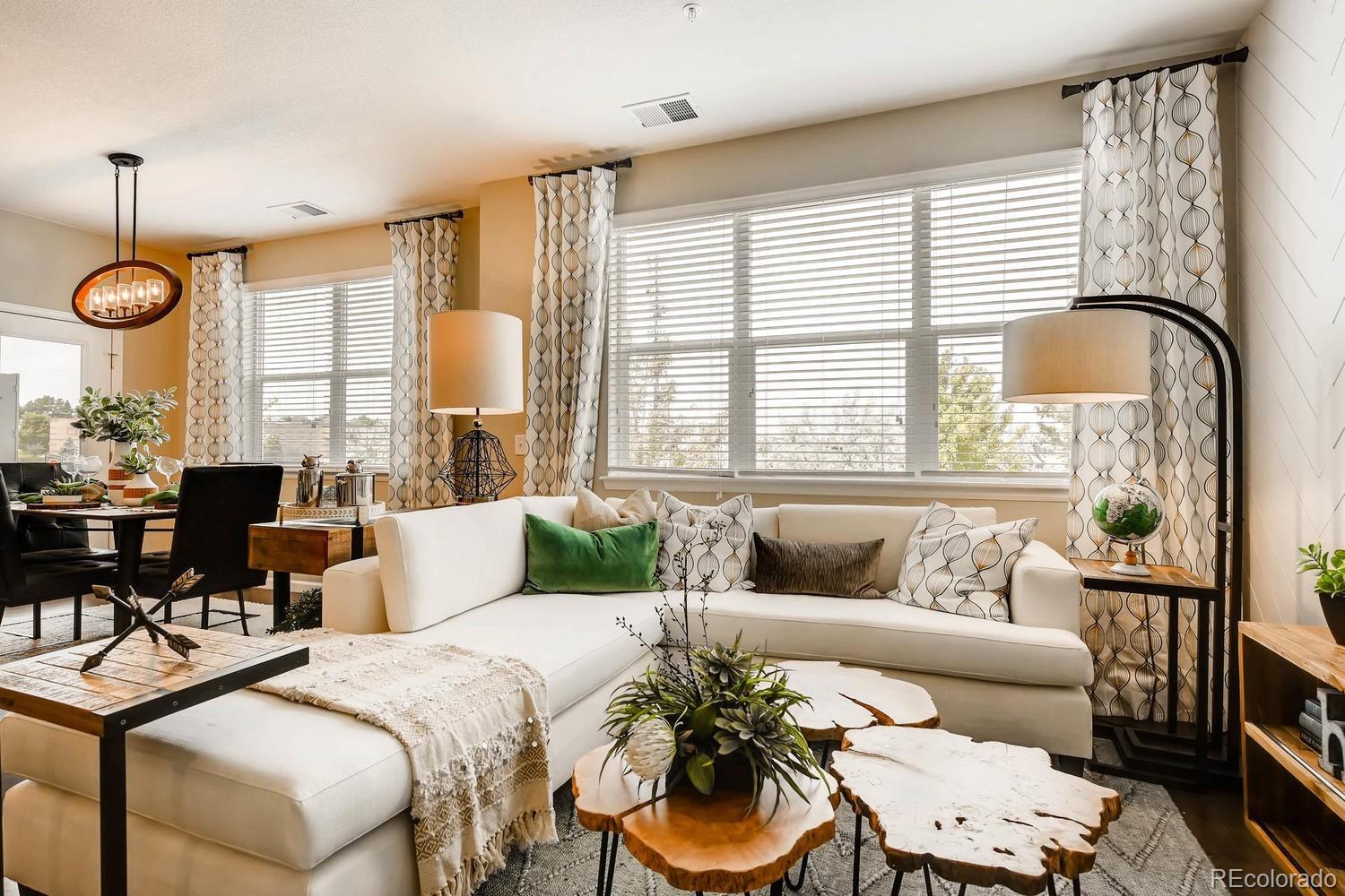 4765 Copeland Circle, Unit 103 Highlands Ranch, CO 80126 - Photo 12 of 28 a living room with furniture and a large window