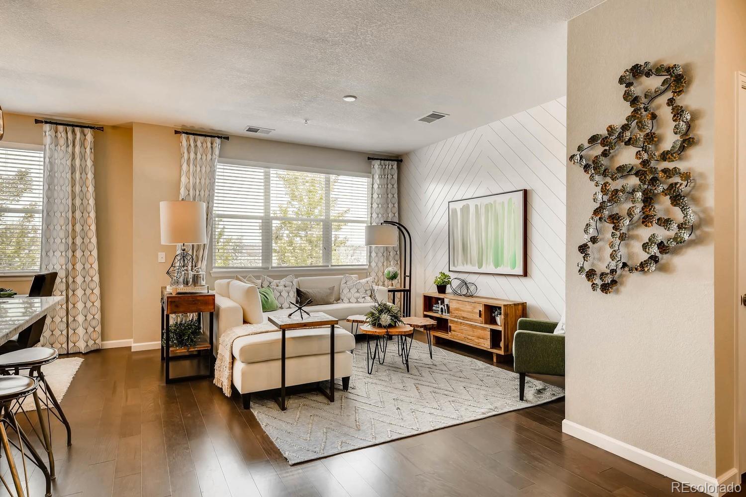4765 Copeland Circle, Unit 103 Highlands Ranch, CO 80126 - Photo 14 of 28 a living room with furniture and a large window