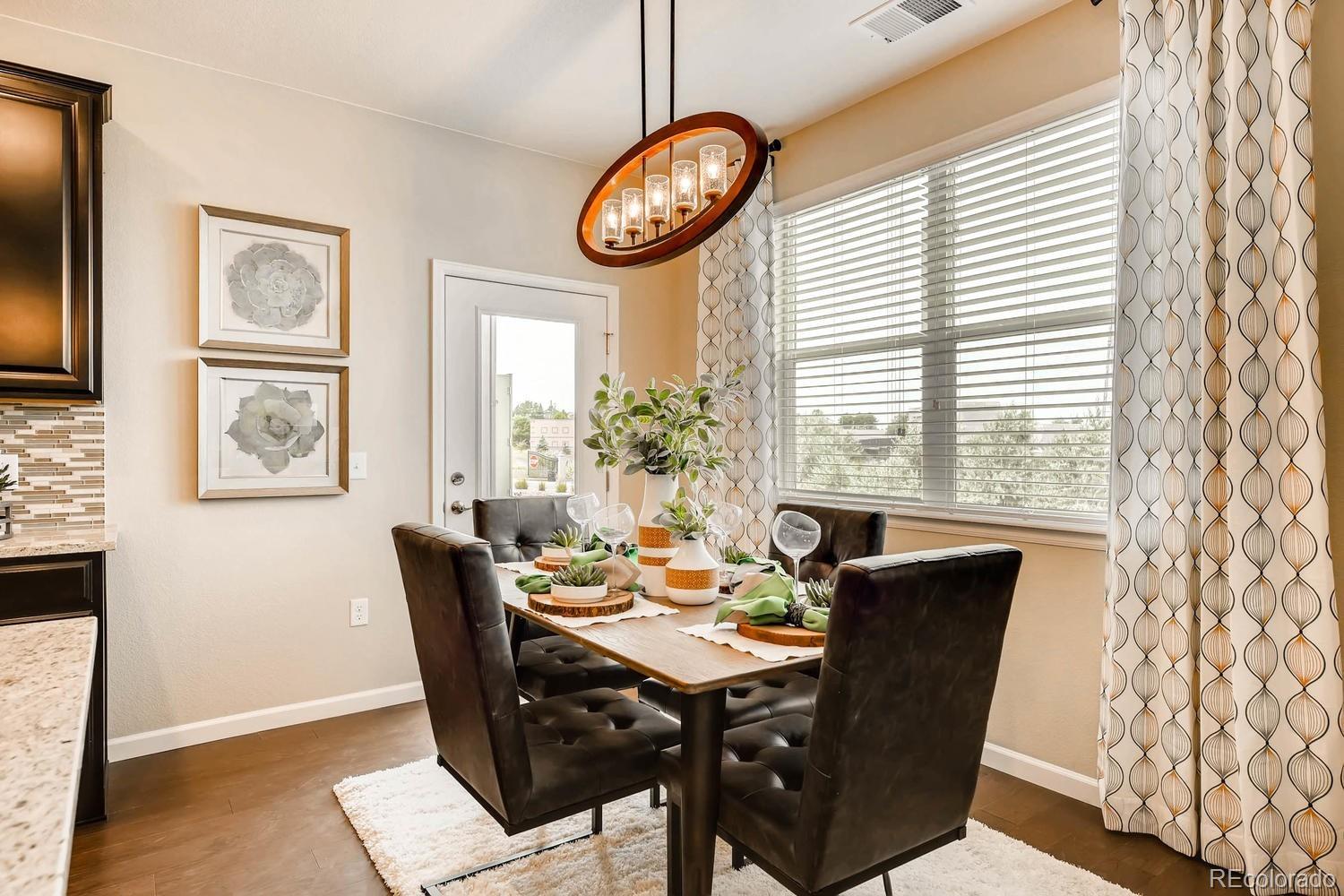 4765 Copeland Circle, Unit 103 Highlands Ranch, CO 80126 - Photo 15 of 28 a view of a dining room with furniture window and wooden floor