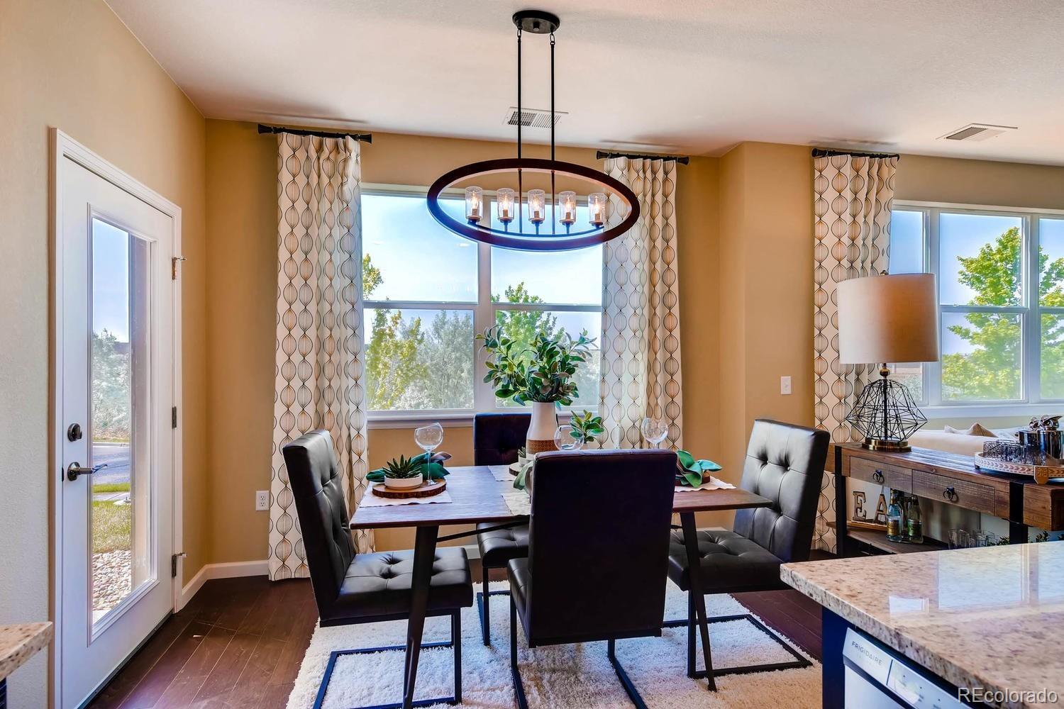 4765 Copeland Circle, Unit 103 Highlands Ranch, CO 80126 - Photo 16 of 28 a view of a dining room with furniture window and wooden floor