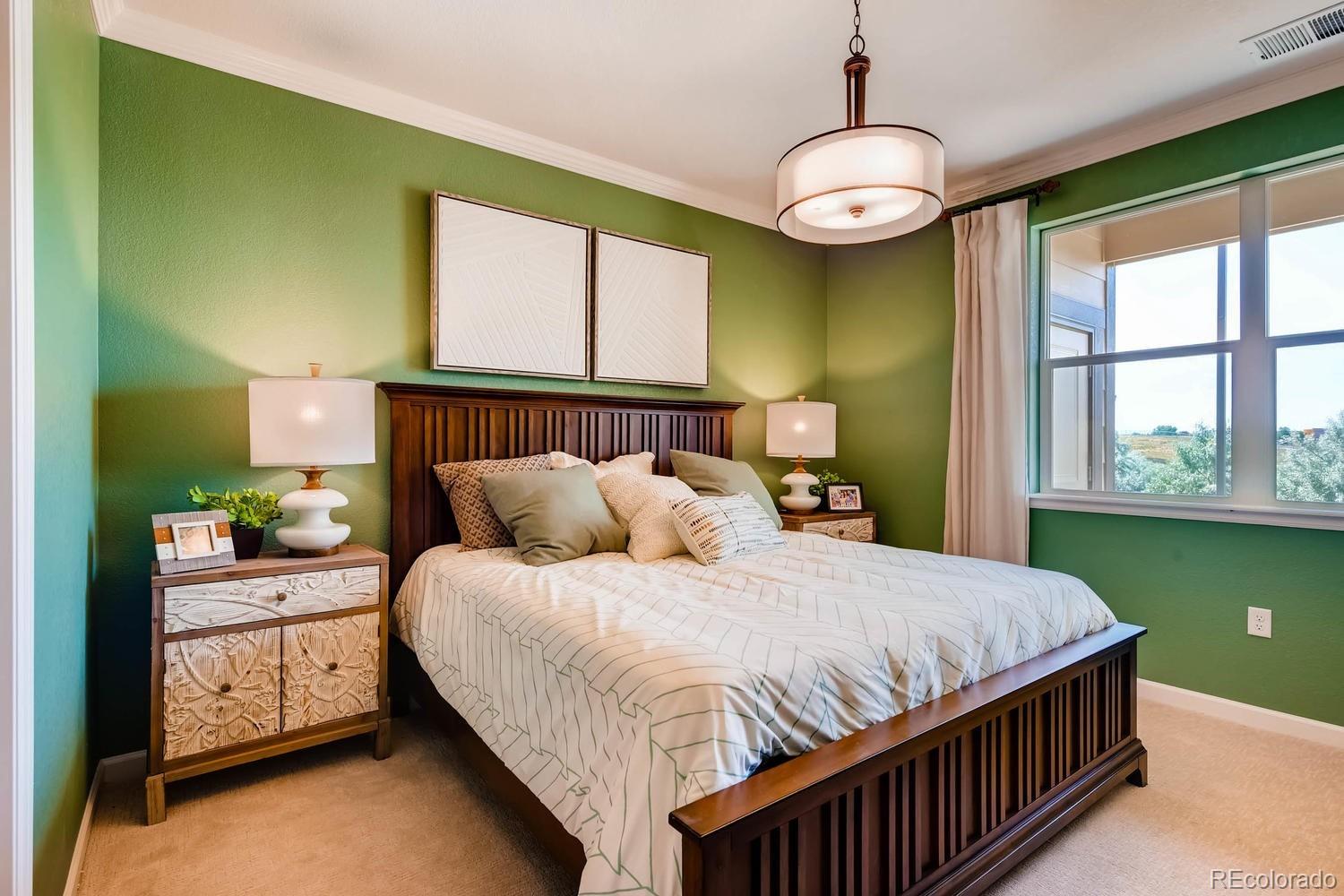 4765 Copeland Circle, Unit 103 Highlands Ranch, CO 80126 - Photo 17 of 28 a bedroom with a bed and windows