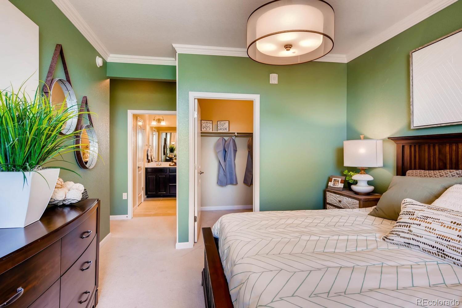 4765 Copeland Circle, Unit 103 Highlands Ranch, CO 80126 - Photo 19 of 28 a bedroom with a bed and a potted plant