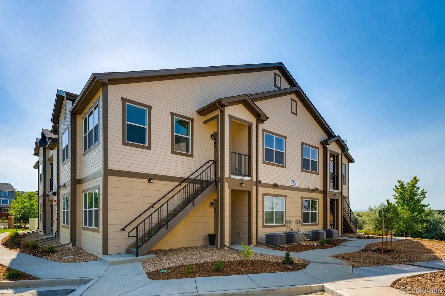4765 Copeland Circle, Unit 103 Highlands Ranch, CO 80126 - Photo 2 of 28 a front view of a house with street