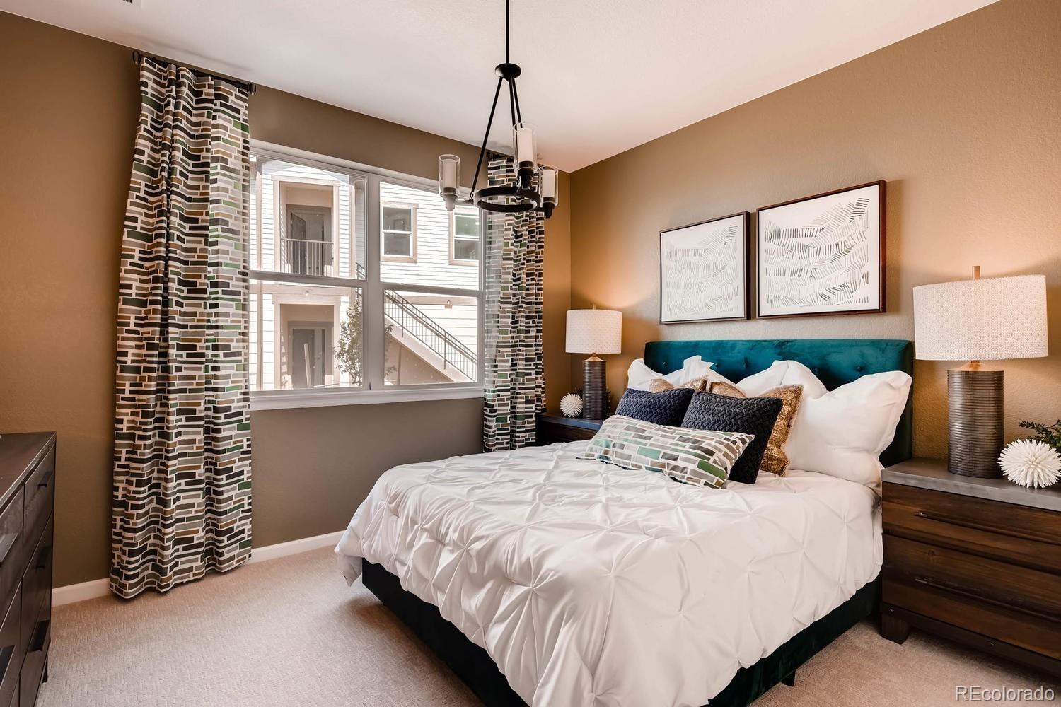 4765 Copeland Circle, Unit 103 Highlands Ranch, CO 80126 - Photo 21 of 28 a bedroom with bed and a window