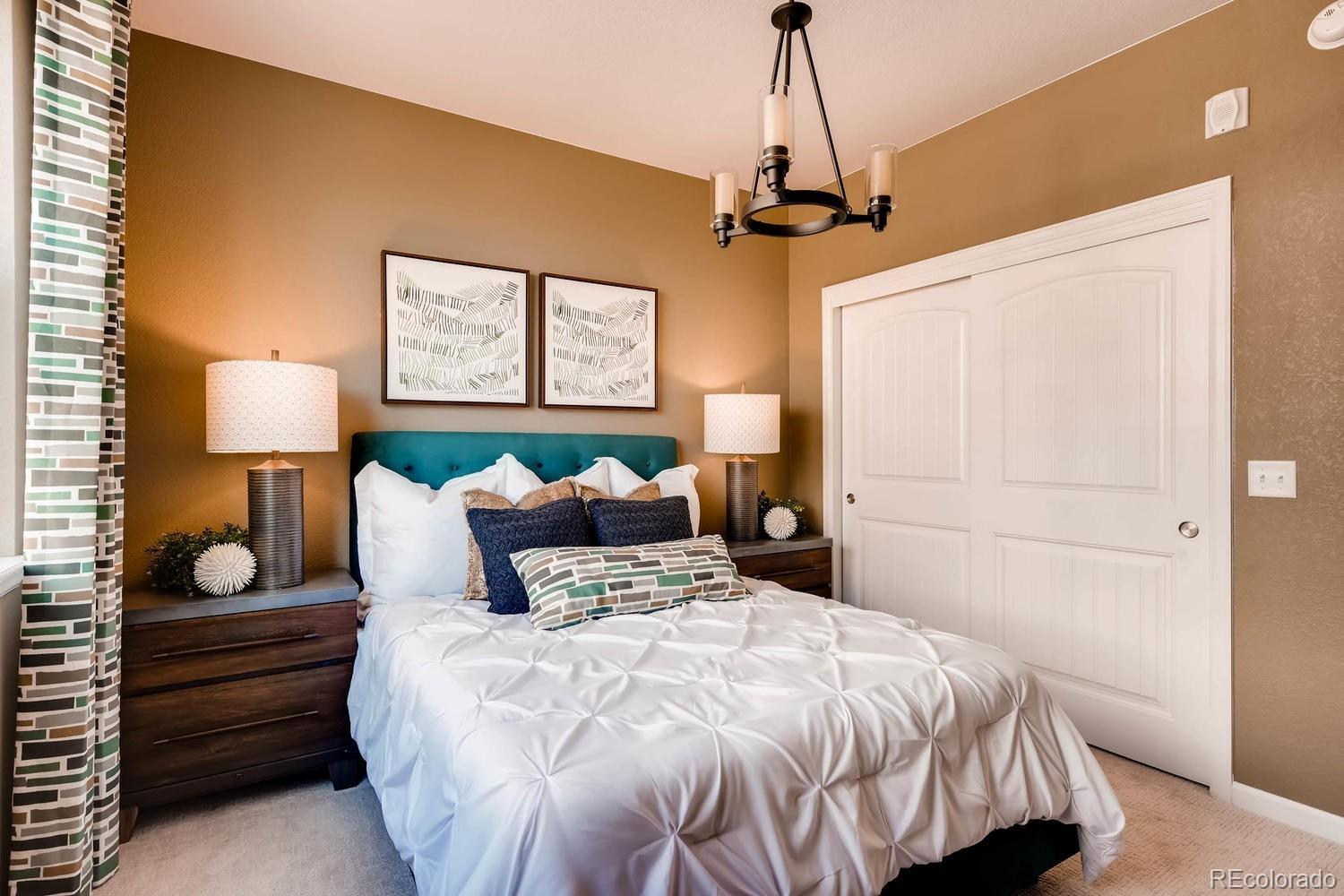 4765 Copeland Circle, Unit 103 Highlands Ranch, CO 80126 - Photo 22 of 28 a bedroom with a bed and a night stand