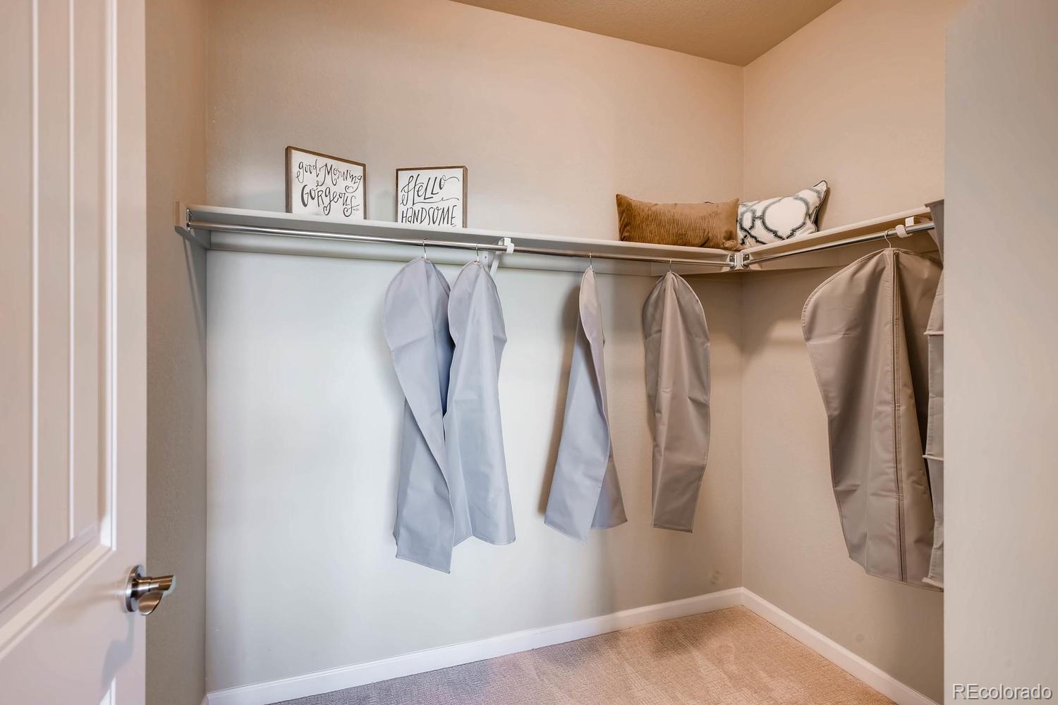 4765 Copeland Circle, Unit 103 Highlands Ranch, CO 80126 - Photo 23 of 28 a view of walk in closet with clothes and shoes