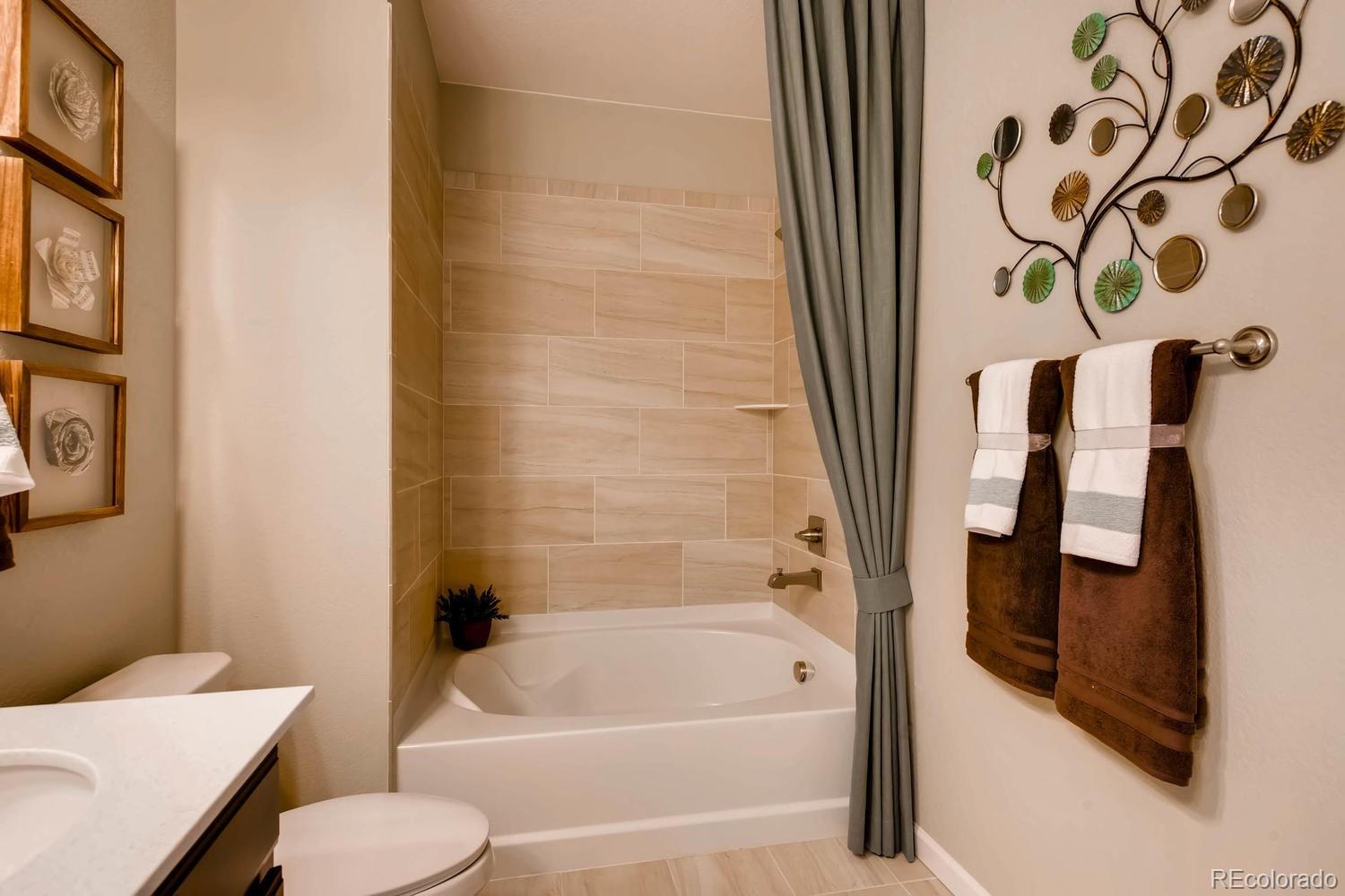 4765 Copeland Circle, Unit 103 Highlands Ranch, CO 80126 - Photo 25 of 28 a bathroom with a toilet and a bathtub
