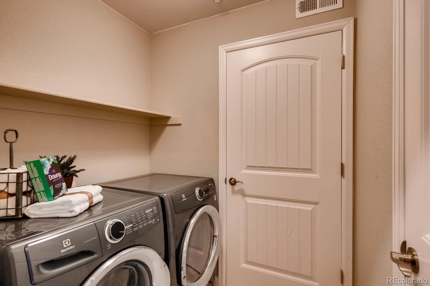 4765 Copeland Circle, Unit 103 Highlands Ranch, CO 80126 - Photo 26 of 28 a utility room with dryer and washer