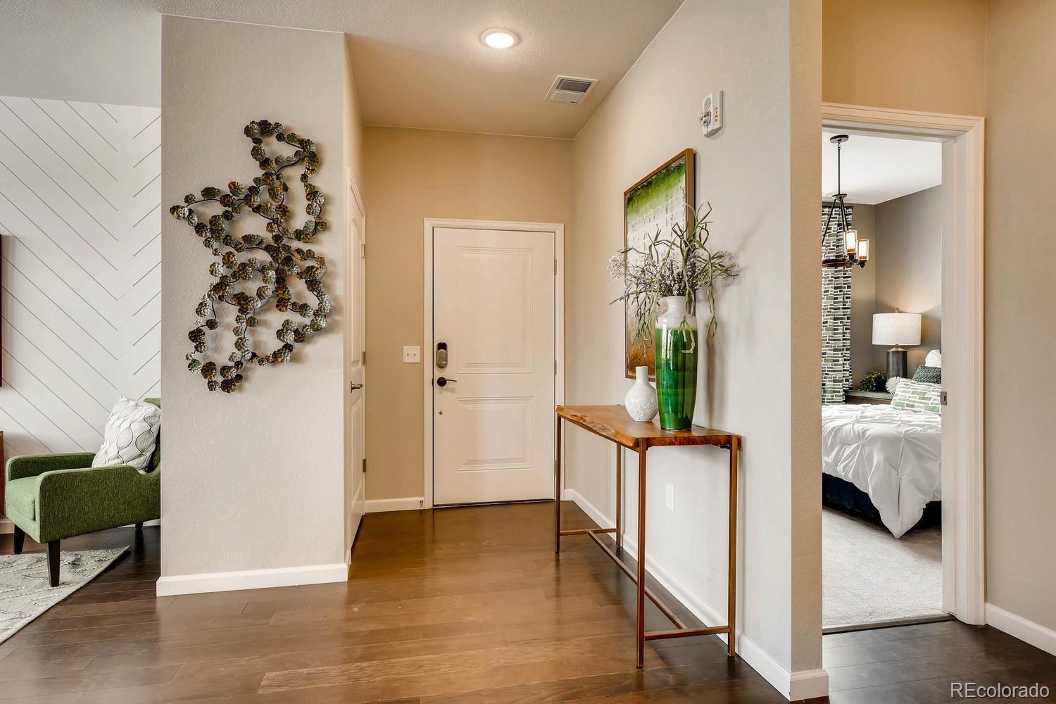 4765 Copeland Circle, Unit 103 Highlands Ranch, CO 80126 - Photo 4 of 28 a view of a hallway with a livingroom and furniture