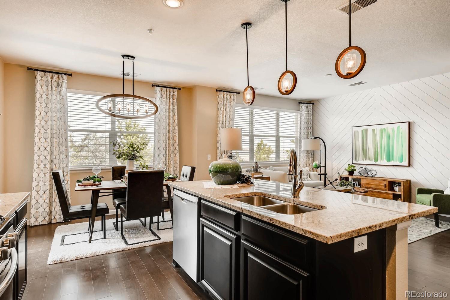 4765 Copeland Circle, Unit 103 Highlands Ranch, CO 80126 - Photo 8 of 28 a kitchen with a table chairs and a chandelier