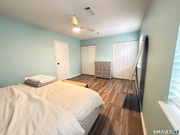a bedroom with a bed and a large window