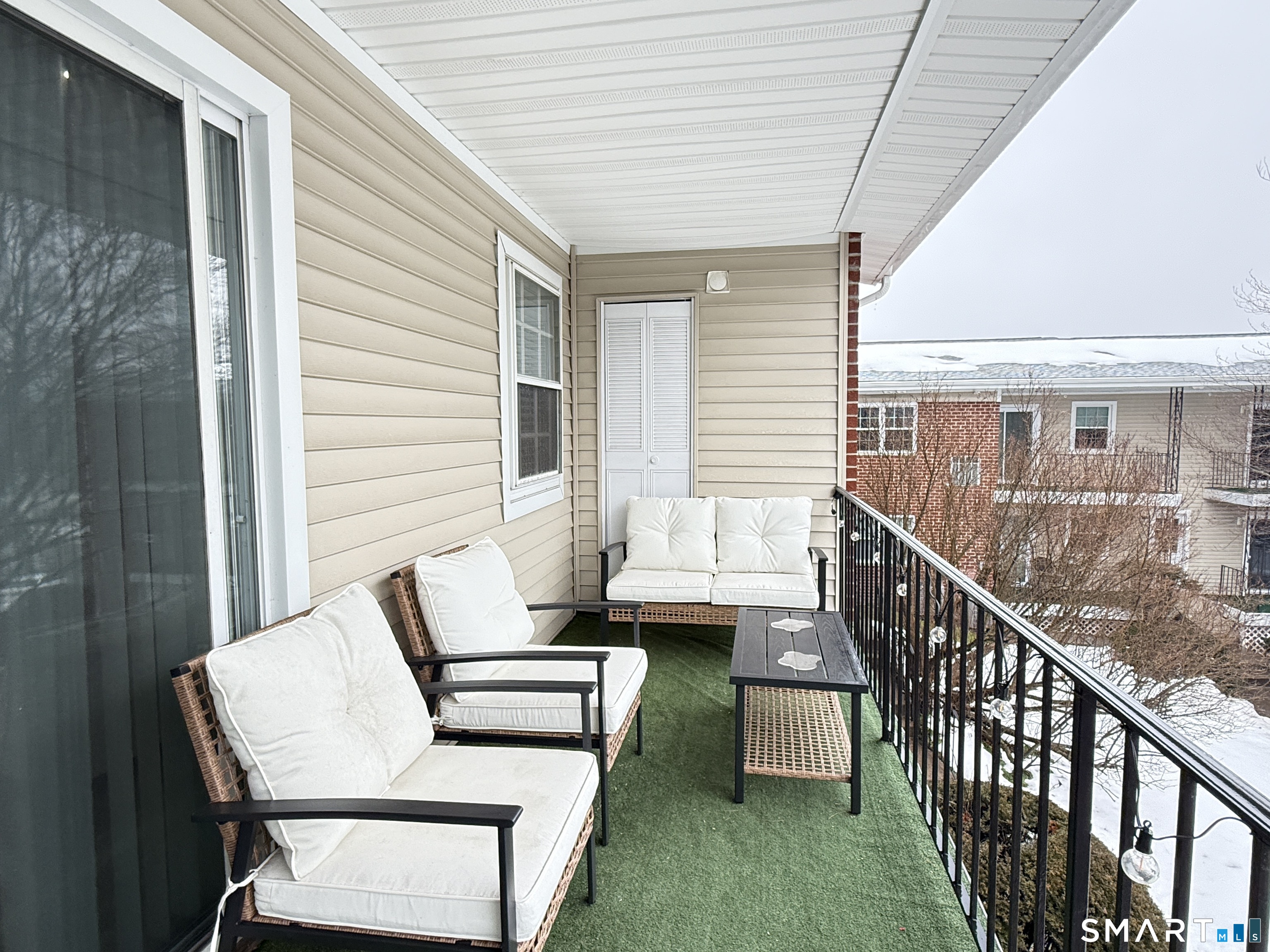 50 Greenhouse Road, Unit 49C Bridgeport, CT 06606 - Photo 12 of 16 a balcony with wooden floor and furniture