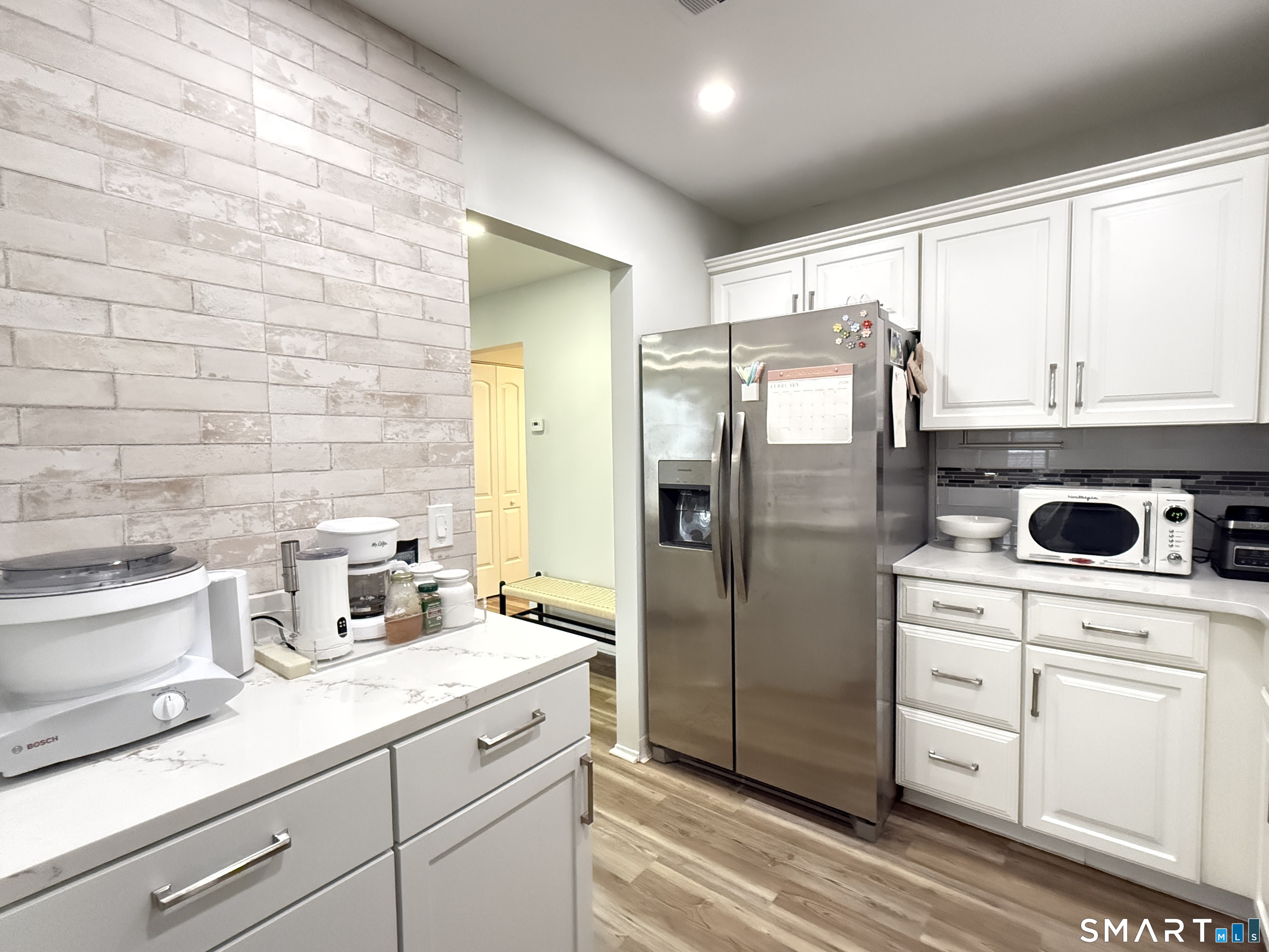 50 Greenhouse Road, Unit 49C Bridgeport, CT 06606 - Photo 2 of 16 a kitchen with a refrigerator sink and cabinets