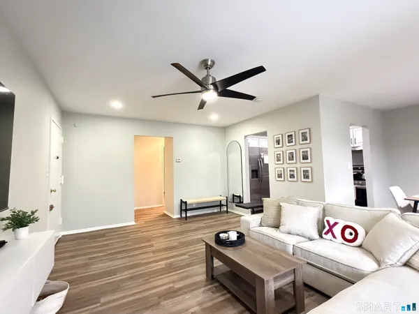 a living room with furniture and wooden floor