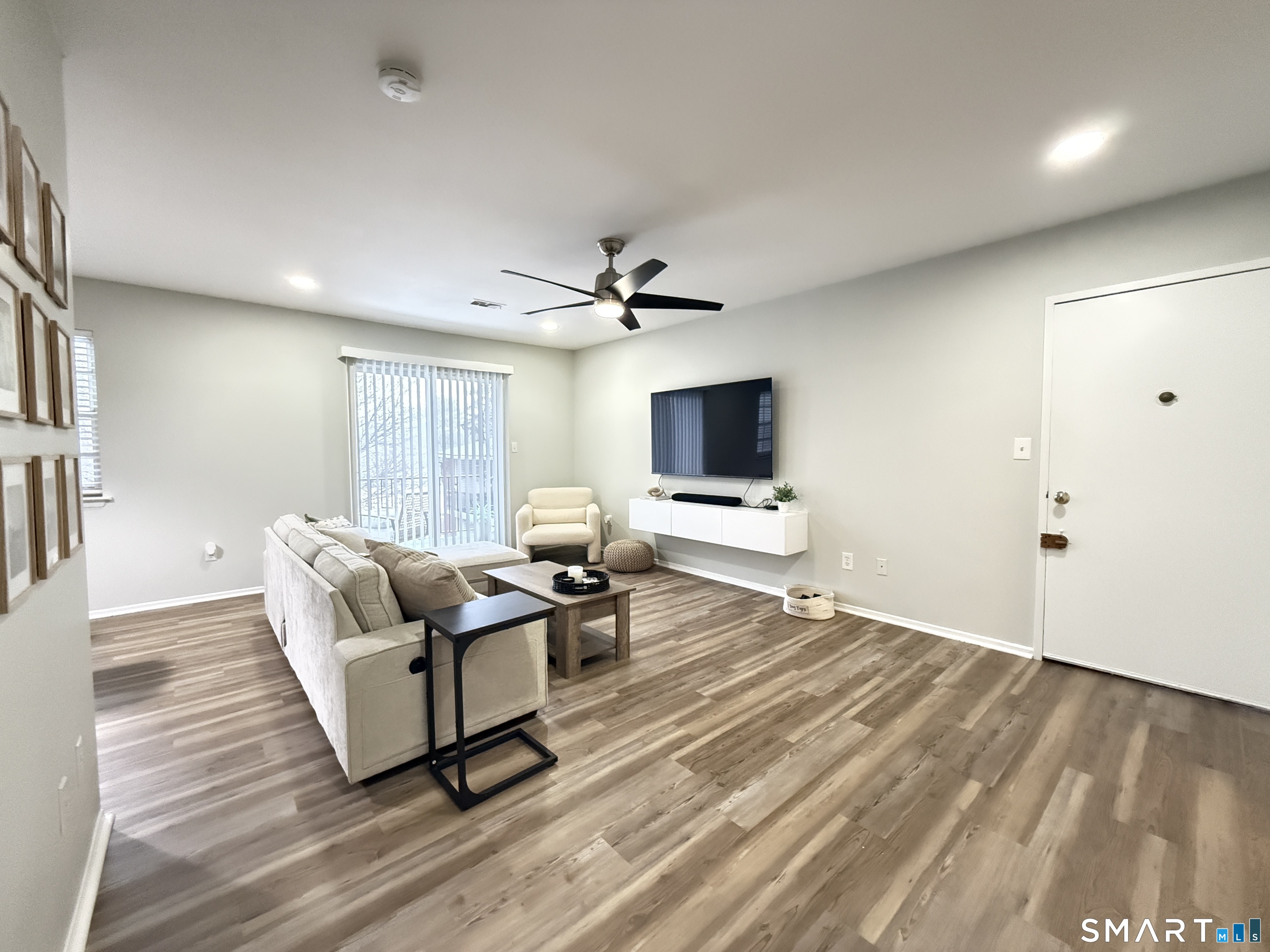 50 Greenhouse Road, Unit 49C Bridgeport, CT 06606 - Photo 7 of 16 a living room with furniture and a flat screen tv