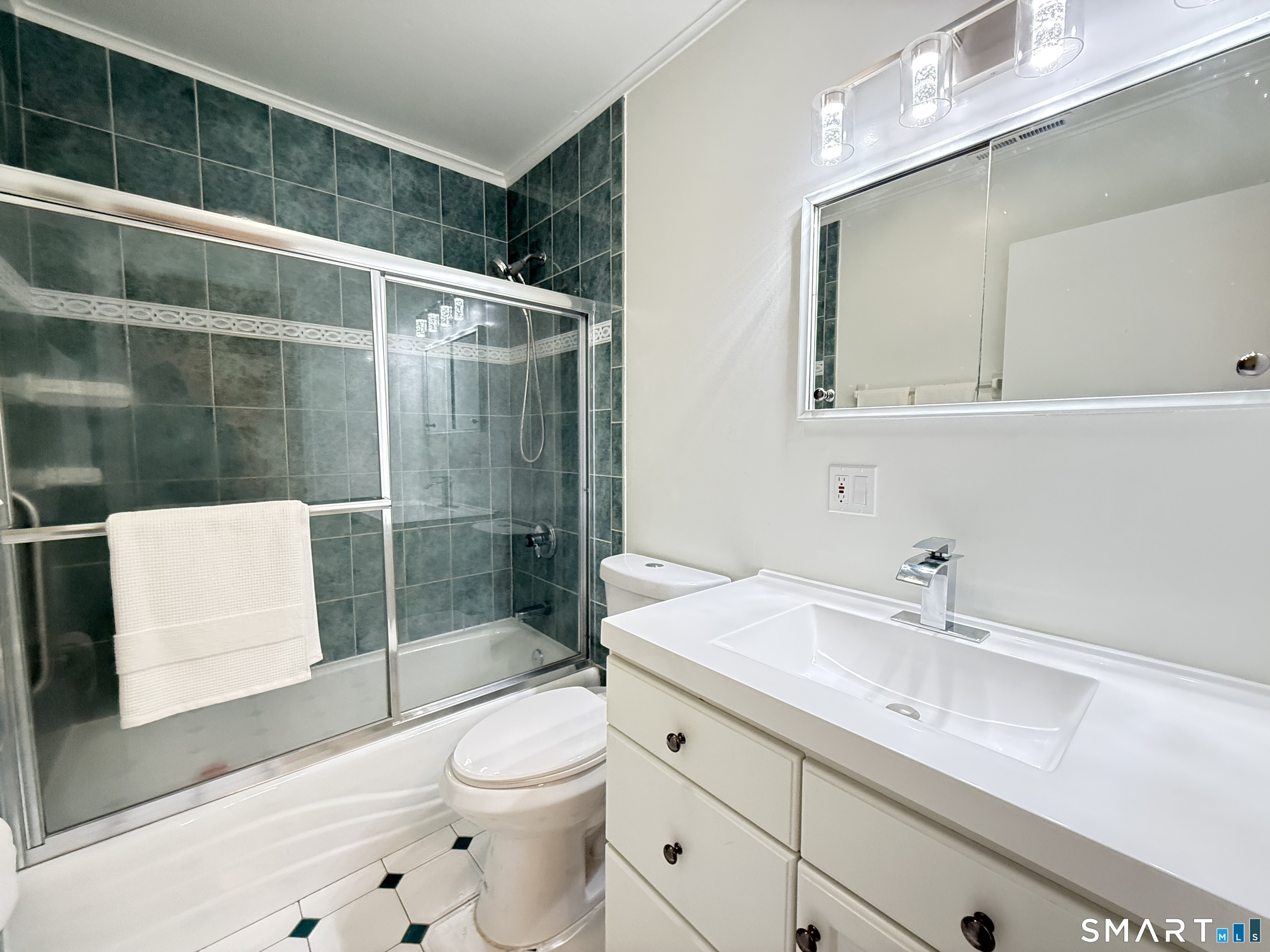 50 Greenhouse Road, Unit 49C Bridgeport, CT 06606 - Photo 9 of 16 a bathroom with a sink a toilet and shower