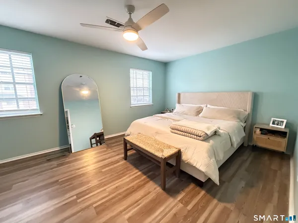 a spacious bedroom with a bed and a window